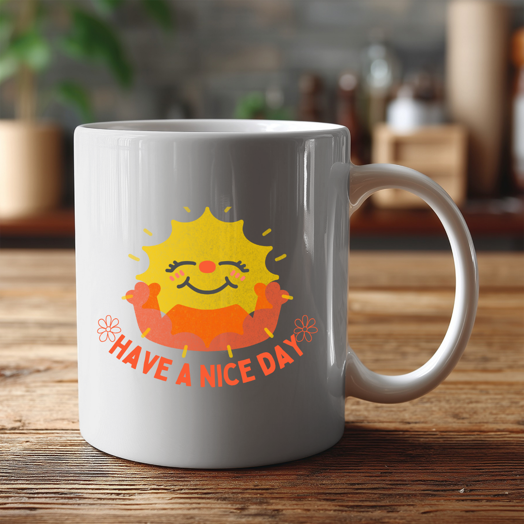 White mug with a sun design and 'Have a nice day' text on a wooden surface.
