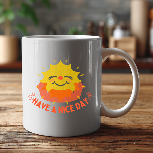 White mug with a sun design and 'Have a nice day' text on a wooden surface.