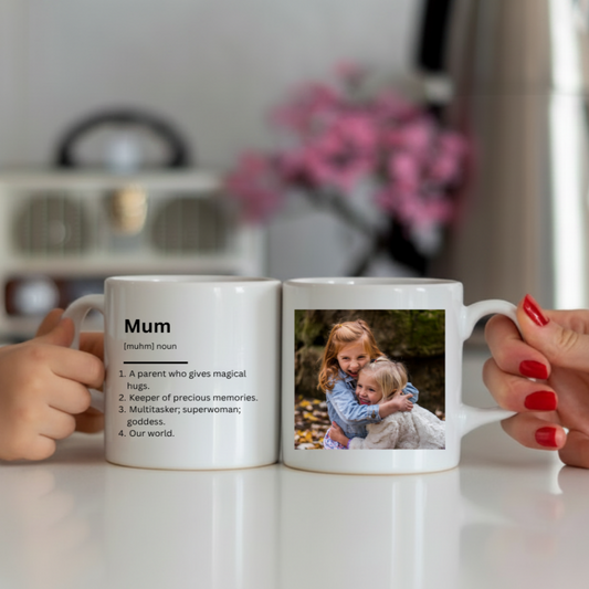 Two hands holding a mug with a photo of two children and text on a kitchen counter.